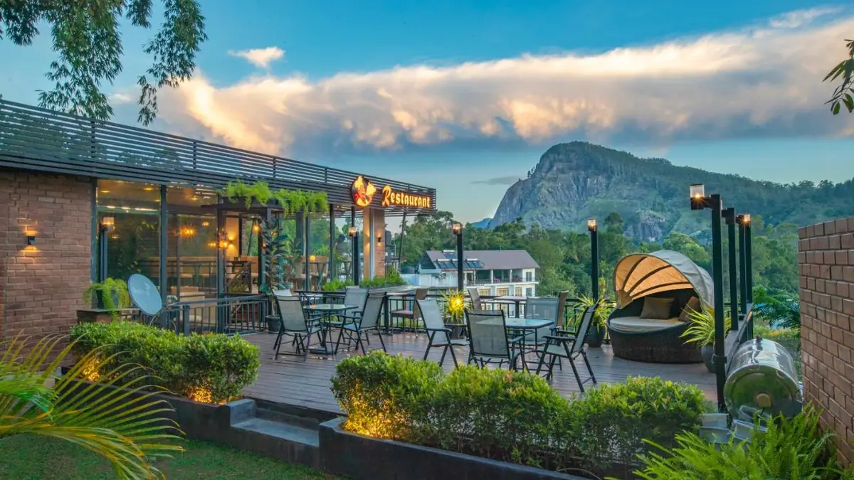 Terrace and garden at Ella Heritage with a view of Ella Rock